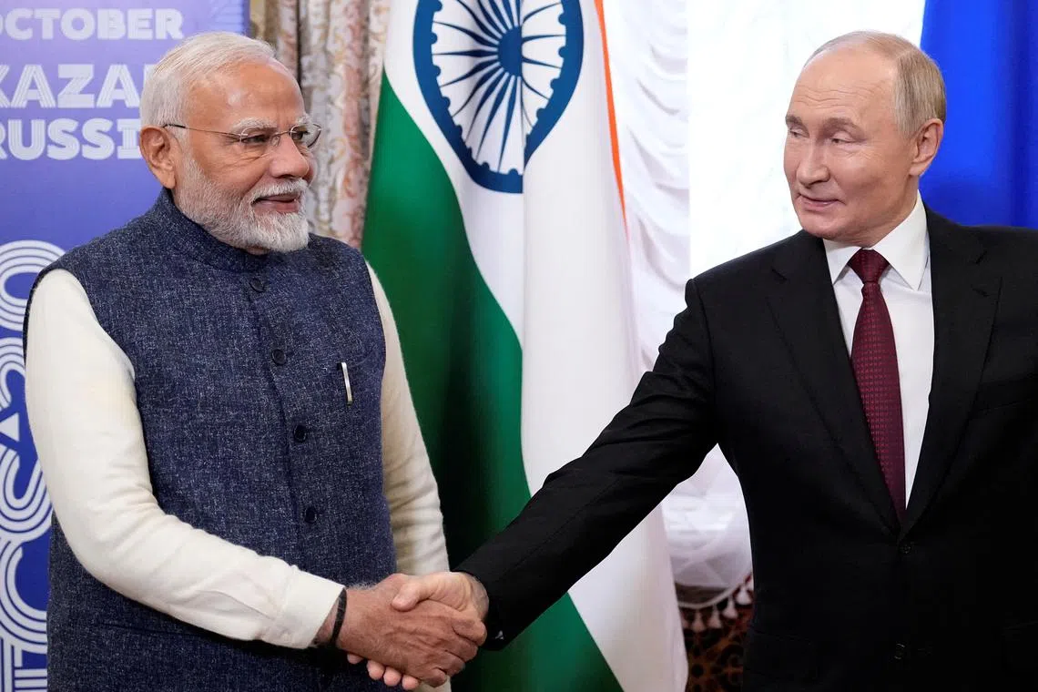 FILE PHOTO: Russian President Vladimir Putin shakes hands with Indian Prime Minister Narendra Modi during their meeting on the sidelines of the BRICS Summit in Kazan, Russia October 22, 2024. Alexander Zemlianichenko/Pool via REUTERS/File Photo