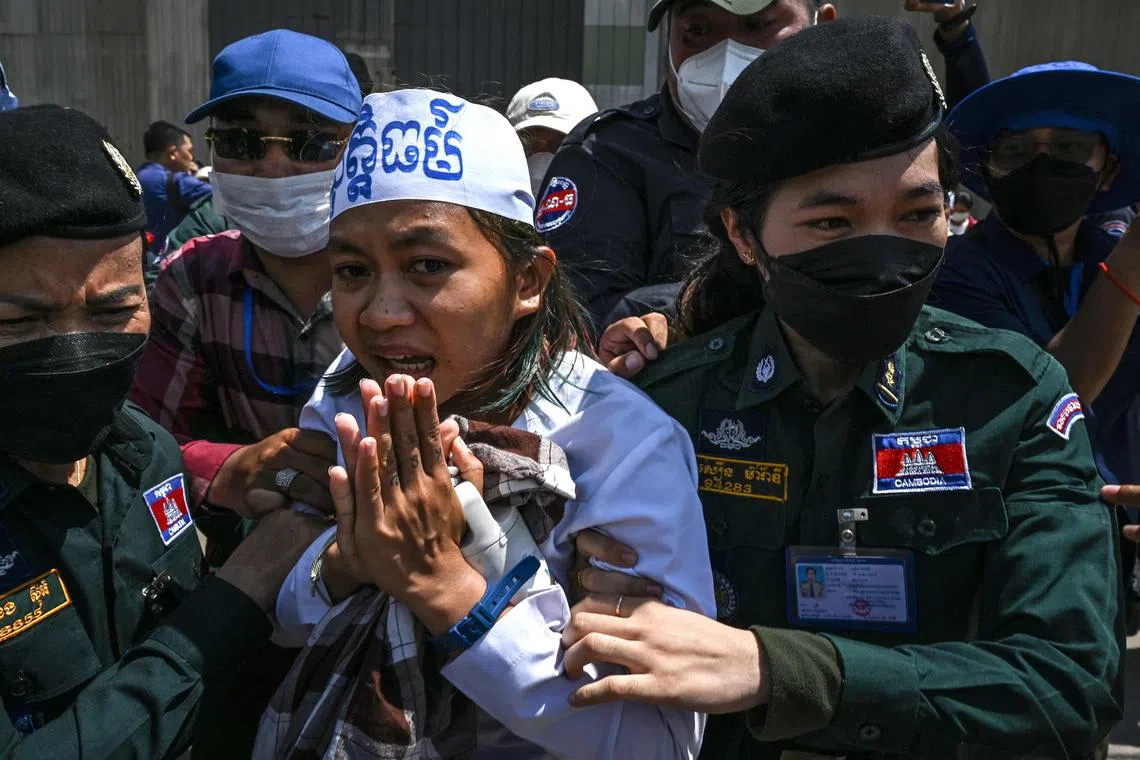 Cambodian environmental activist Phuon Keoraksmey is arrested outside the Phnom Penh municipal court on July 2.