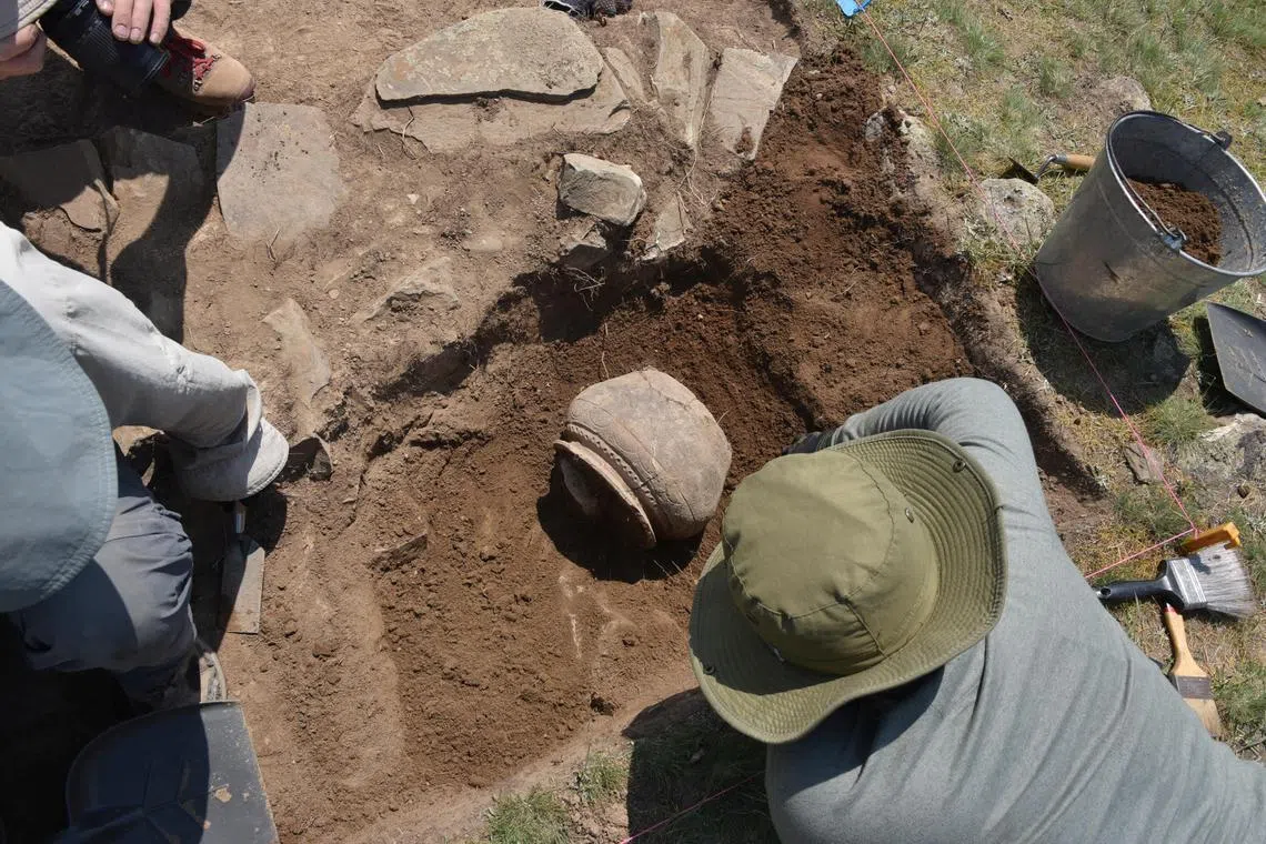 FILE PHOTO: Researchers excavate medieval pottery at the newly rediscovered medieval Silk Road city Tugunbulak located in the mountains of southeastern Uzbekistan June 8, 2022  Michael Frachetti/Handout via REUTERS./File Photo