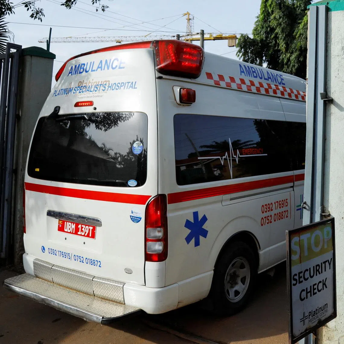 An ambulance drives past an advocacy poster against the spread of the Ebola virus, as aid agencies intensify efforts to contain a new Ebola outbreak involving the Bundibugyo Virus at the Platinum Medical Centre in Kampala, Uganda, May 26, 2026.