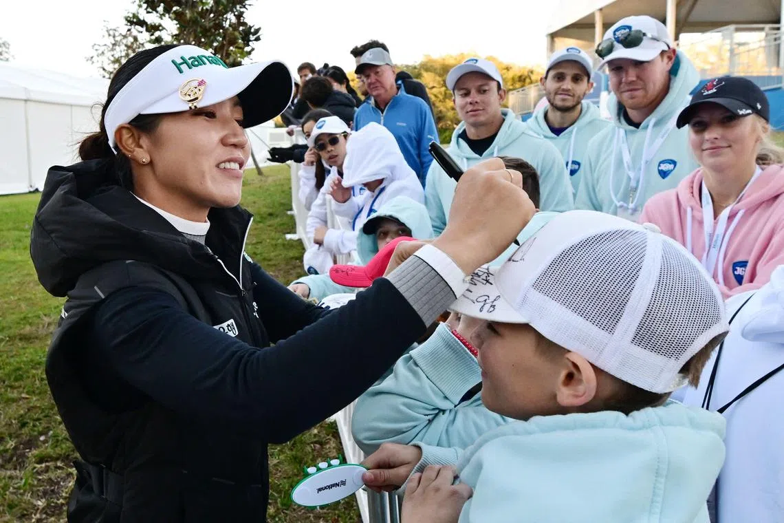 Lydia Ko of New Zealand signing an autograph for a fan after the third round of the Tournament of Champions at Lake Nona Golf & Country Club on Jan 20 in Orlando, Florida. She carded a four-under 68 on Jan 20 to remain atop the leaderboard after three rounds.
