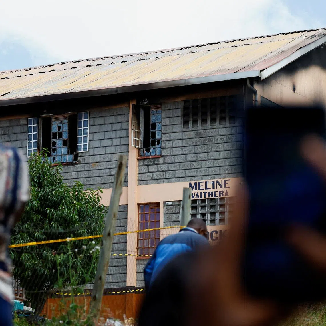 Parents take photographs of the ruins of the dormitory following an overnight fire at the Utumishi Girls' Academy Senior School in Gilgil, Nakuru county, Kenya May 28, 2026. REUTERS/Thomas Mukoya