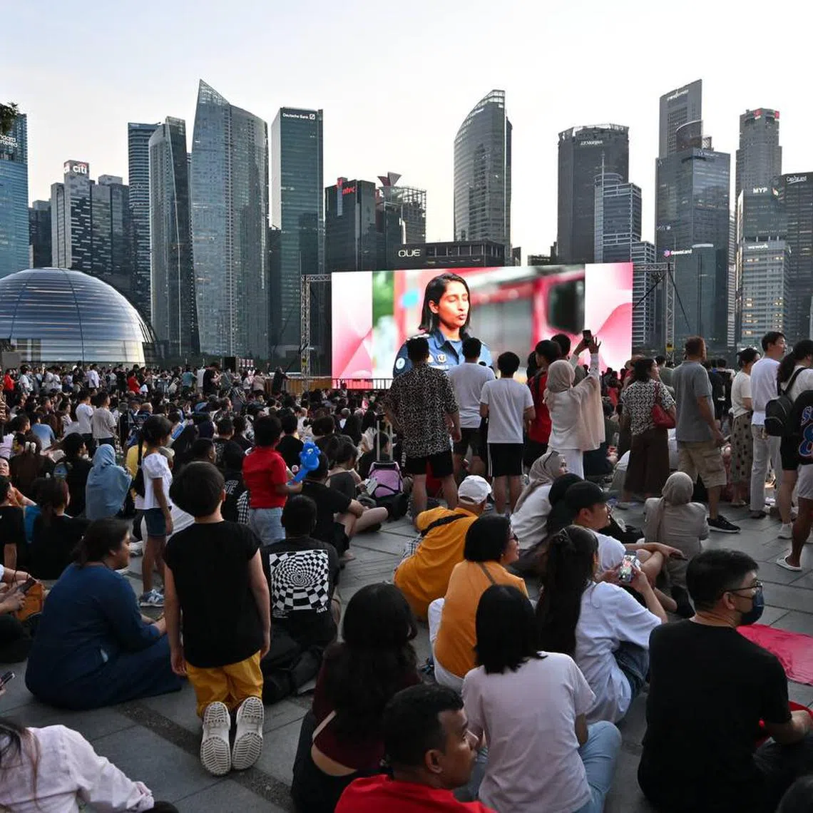 A crowd gathers to watch the National Day Parade preview 2 at Marina Bay Sands waterfront.