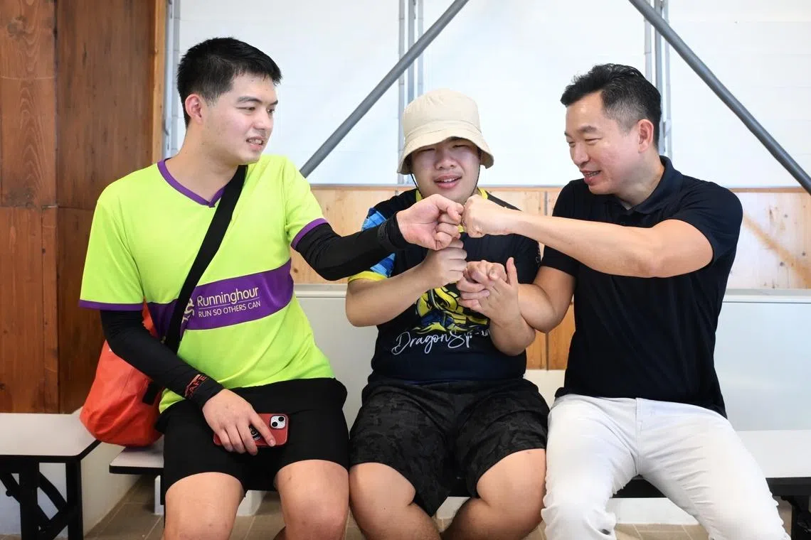 From left: Purple Paddle Fest Participants Wesley Neo, Xavier Ong and Eric Chua, Senior Parliamentary Secretary for the Ministry of Law and the Ministry of Social and Family Development, exchanging fist bumps at the Purple Paddle Fest on July 5, 2026.