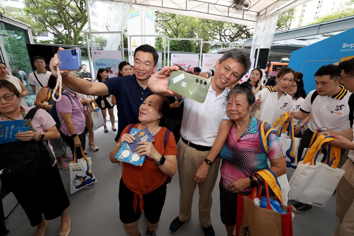 Senior Parliamentary Secretary for Culture, Community and Youth & Social and Family Development Eric Chua (left) and Education Minister Chan Chun Sing with participants at a DBS/POSB bank event on March 15.
