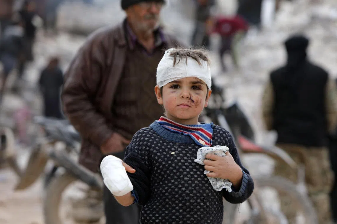 Musa Hmeidi, a Syrian child who was pulled out alive from under the rubble of a collapsed building on February 10, 2023, four days after a deadly earhquake hit the area, in the rebel-held town of Jindayris, in the rebel-held part of Aleppo province, is pictured hours after he was rescued. - The 7.8-magnitude tremor, has claimed the lives of some 22,000 people in Turkey and Syria. (Photo by Bakr ALKASEM / AFP)