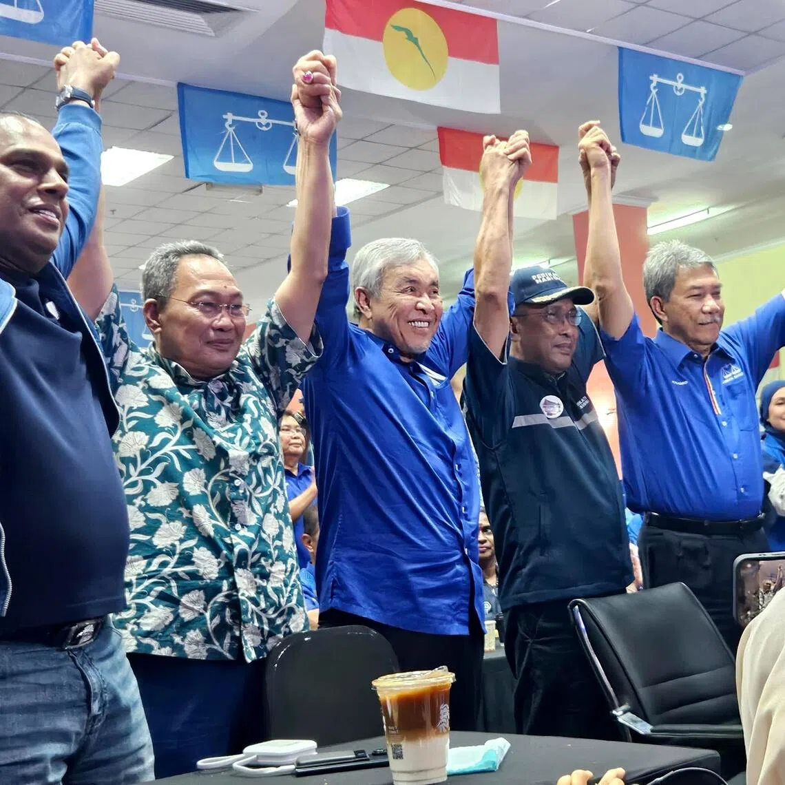 Perikatan Nasional secretary-general Takiyuddin Hassan (centre), flanked by Barisan Nasional president Ahmad Zahid Hamidi (centre, left) and BN Negeri Sembilan chairman Mohamad Hasan at the UMNO Negeri Sembilan headquarters on Aug 1.