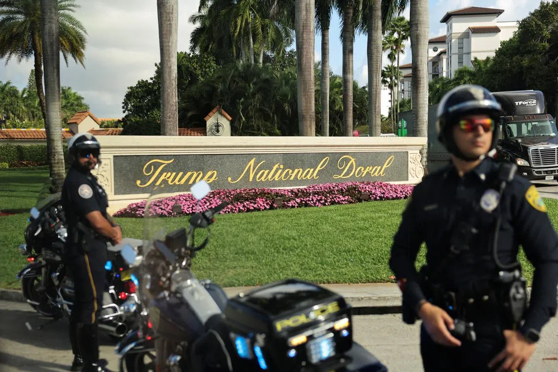 FILE PHOTO: Police keep watch as the motorcade of U.S. President Donald Trump arrives at Trump National Doral golf club in Miami, Florida, U.S., February 19, 2025. REUTERS/Kevin Lamarque/ File Photo