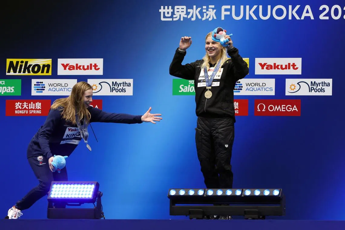 Silver medallist Lilly King (left) of the United States and gold medallist Ruta Meilutyte of Lithuania gesturing on the podium of the women's 50m breaststroke event of the swimming events during the World Aquatics Championships 2023 in Fukuoka on Sunday.