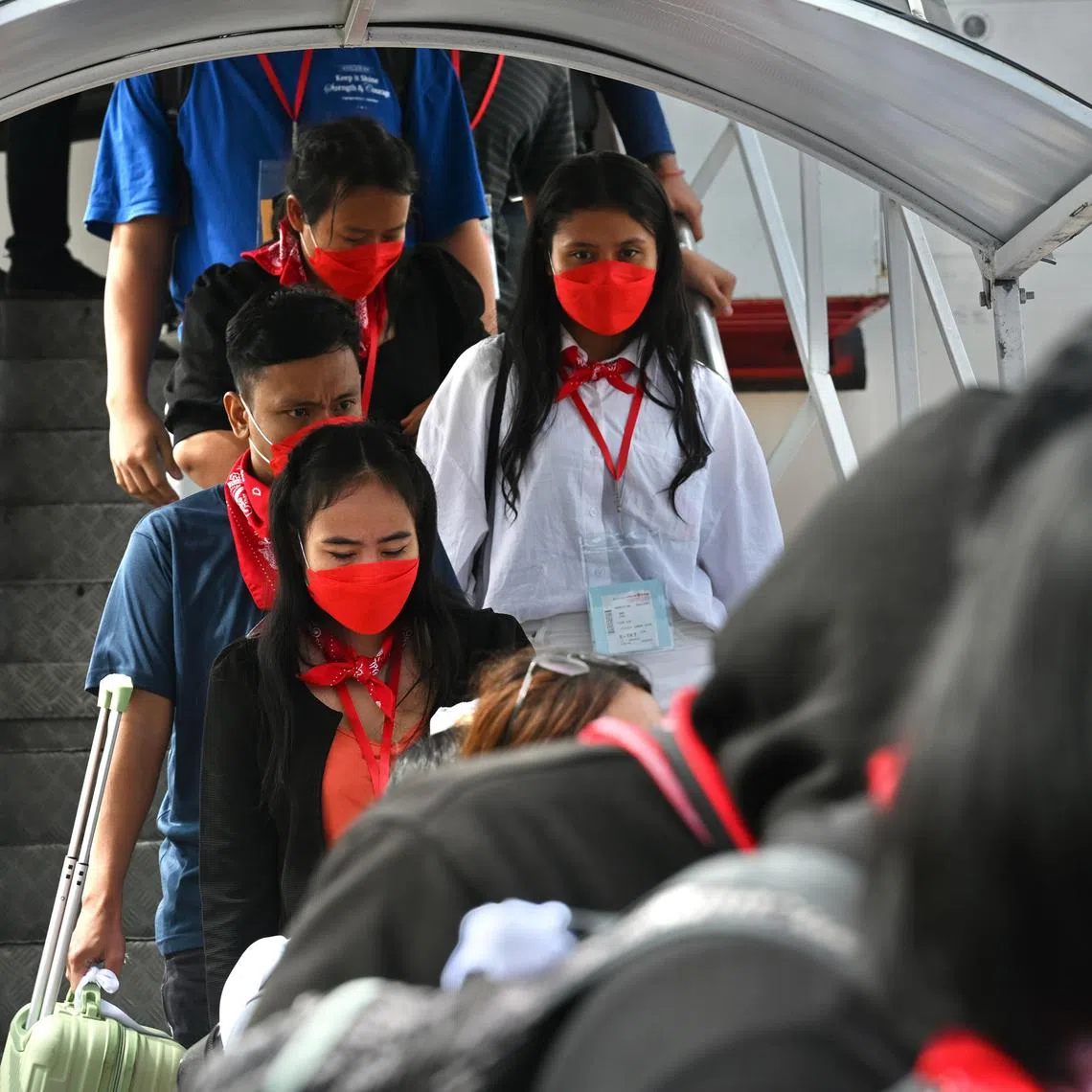 Indonesian workers arriving at Jakarta airport on March 18, 2025, after their rescue from Myanmar online scam compounds. 