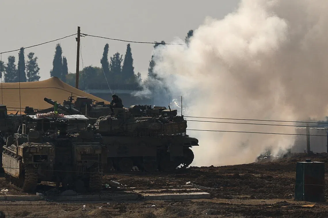An Israeli soldier sits on top of a tank at a camp, amid the ongoing conflict between Israel and Hamas, near the Israel-Gaza border, in Israel, January 12, 2025. REUTERS/Kai Pfaffenbach