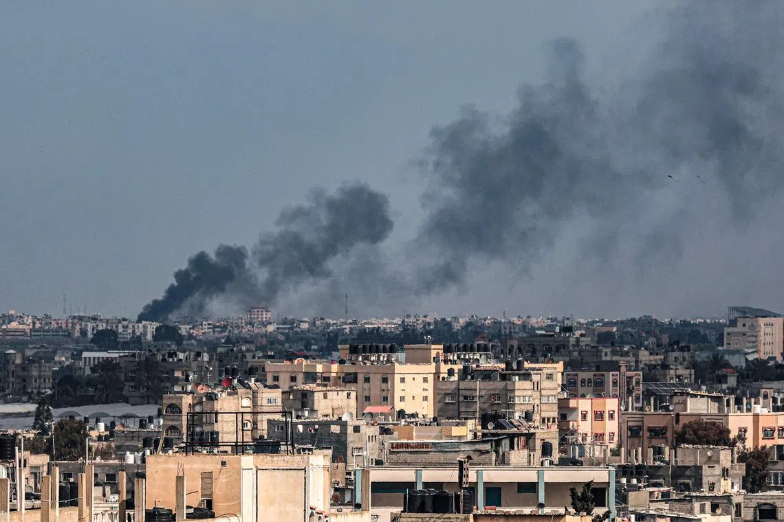 Smoke billows over Khan Younis in the southern Gaza Strip during Israeli bombardment on Feb 20.