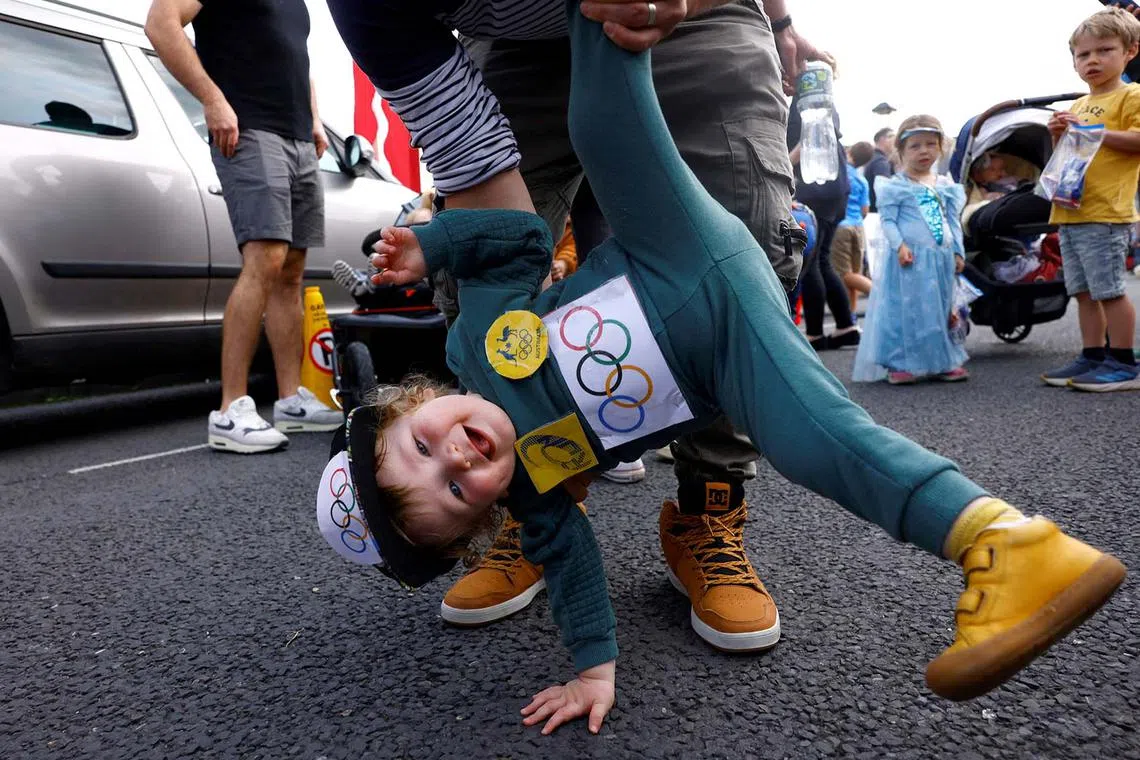 Brodie White, 1, dressed as the Australian Olympic breakdancer Rachael Gunn, known by her competition name Raygun who participated in the sport of Breaking, is held by his dad at a children's fancy dress parade at the Cruinniu na mBad (gathering of the boats) regatta in Kinvara, Ireland August 18, 2024. REUTERS/Clodagh Kilcoyne TPX IMAGES OF THE DAY