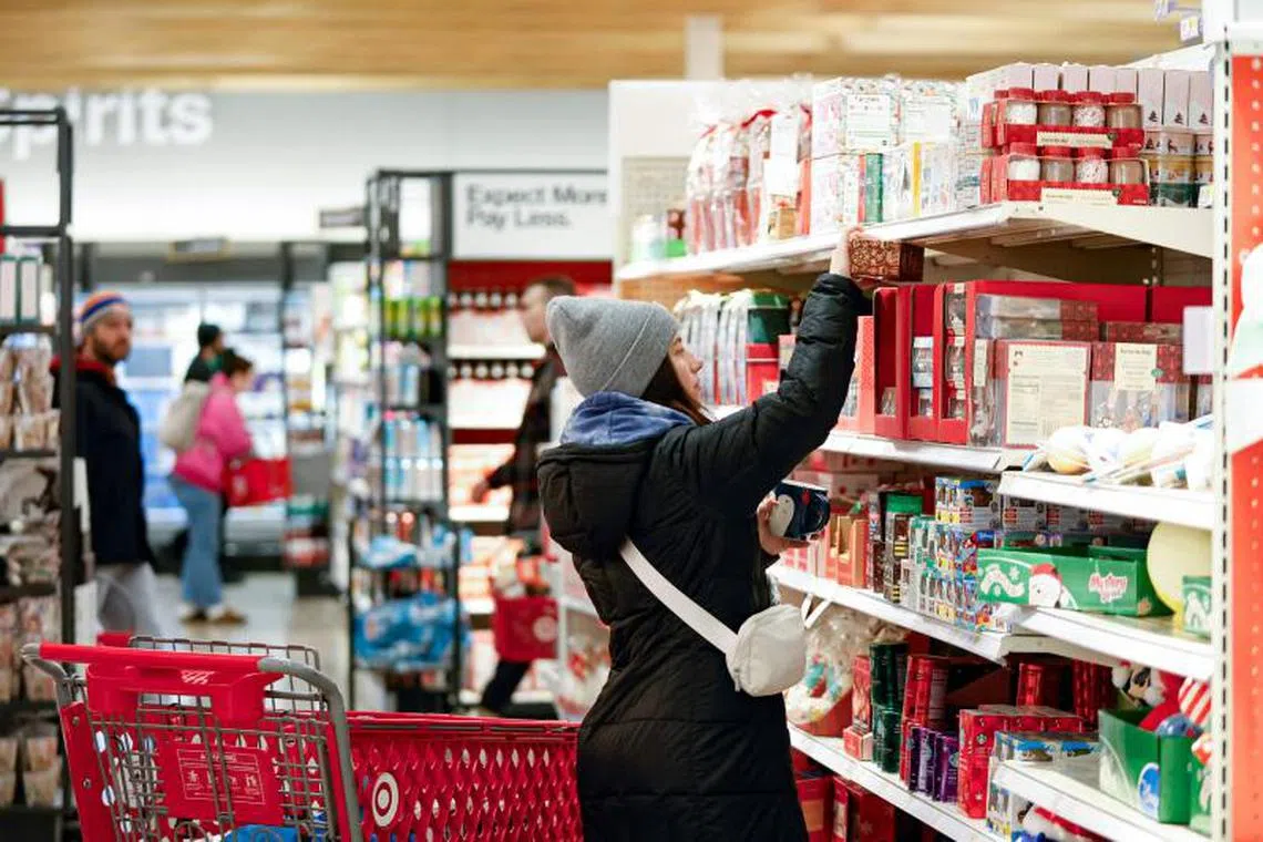 A woman shops at a Target store in Chicago on November 26, 2024, ahead of the Black Friday shopping day. (Photo by KAMIL KRZACZYNSKI / AFP)