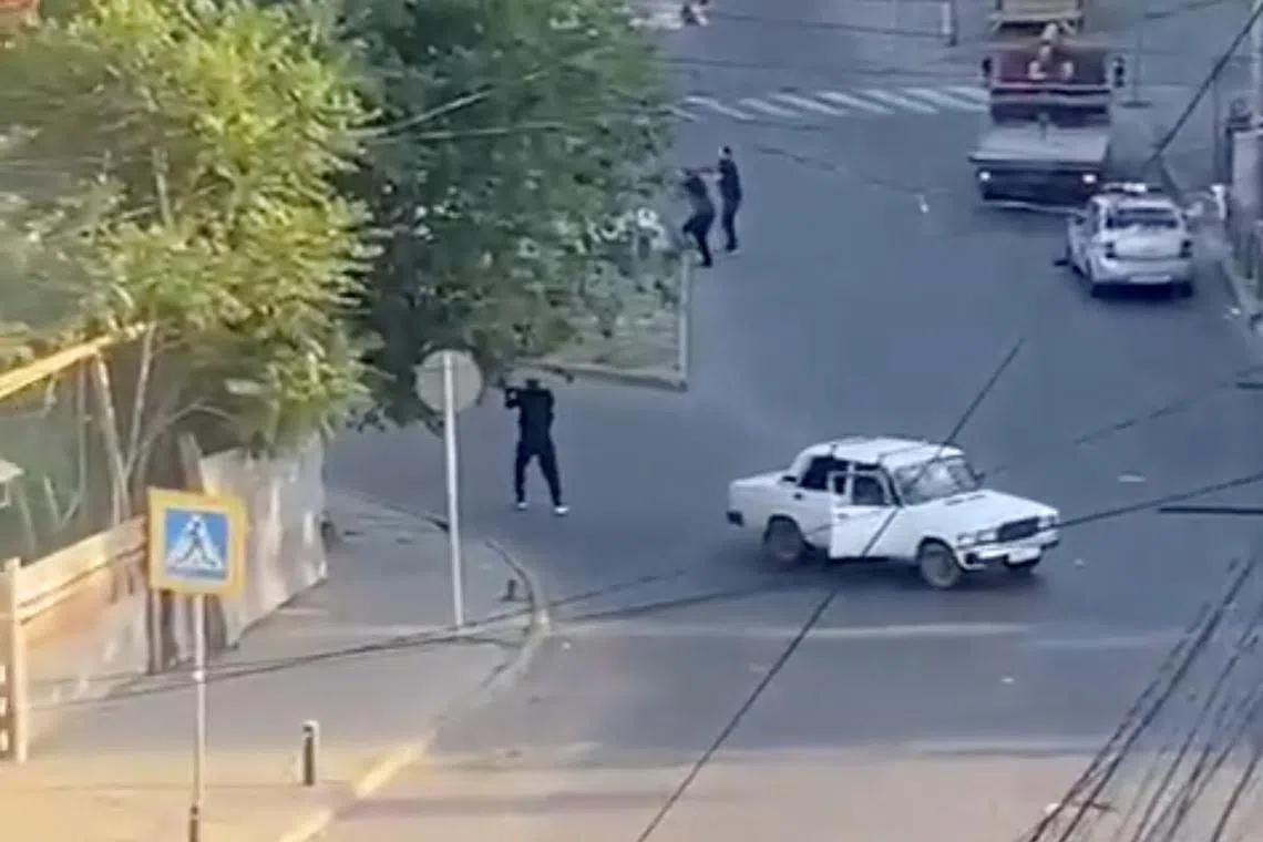 A screengrab taken from a video released on June 23, 2024,  shows a shooting scene on the street of Makhachkala, Dagestan, in southern Russiain.