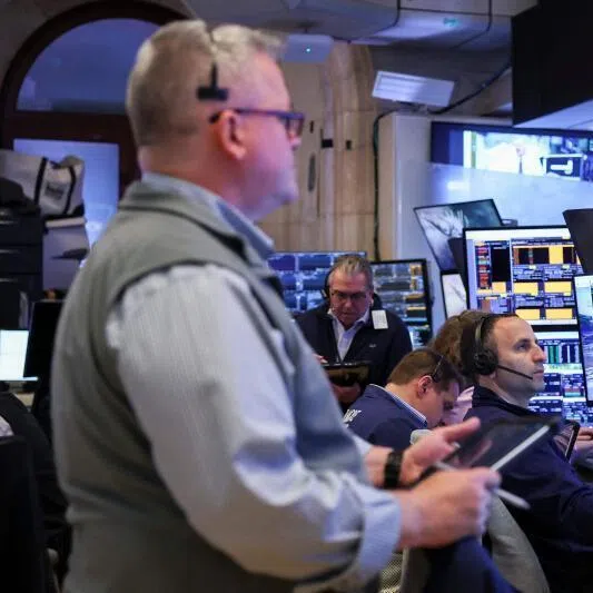 Traders work on the floor of the New York Stock Exchange during the opening bell in New York, on May 11.