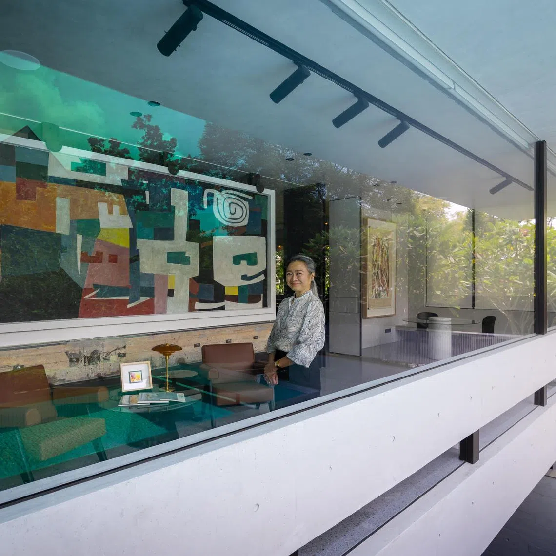 Ms Audrey Koh in her home at 5 Kingsmead Road . Behind her is the mural titled “Studio” painted by pioneering Singaporean artist Chen Wen Hsi.