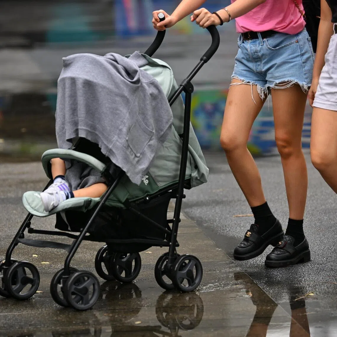 Generic photo of a baby being pushed in a covered pram protected from the rain on March 6, 2023. 
can be used for children, kids, stories. 