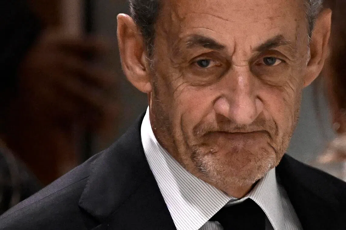 Former French president Nicolas Sarkozy leaves after the verdict in his trial for illegal campaign financing from Libya for his successful 2007 presidential bid, at the Tribunal de Paris courthouse in Paris, on September 25, 2025. A Paris court on September 25, 2025 sentenced former French president Nicolas Sarkozy to five years and ordered him to go to prison after finding him guilty of criminal conspiracy over accusations the late Libyan dictator Moamer Kadhafi helped fund his victorious 2007 presidential run. The court ordered that Sarkozy should be placed in custody at a later date, with prosecutors given one month to inform the former head of state when he should go to prison. (Photo by JULIEN DE ROSA / AFP)