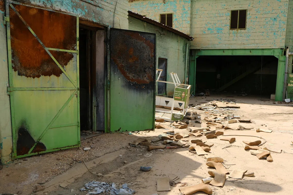Safety shoes are scattered in a destroyed factory in Omdurman, Sudan October 14, 2025. REUTERS/El Tayeb Siddig