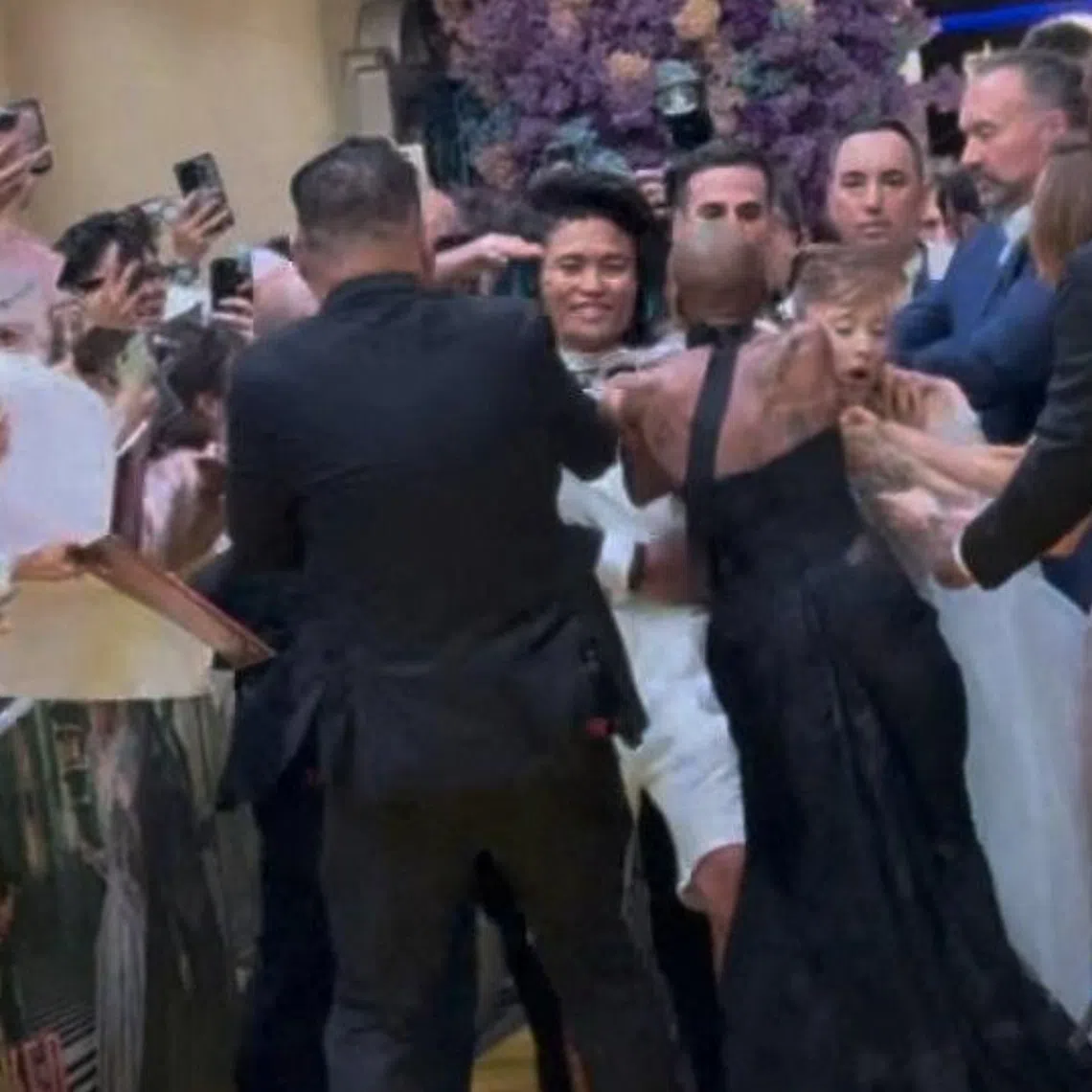 A man jumped a barricade and charged at Ariana Grande during Wicked: For Good's yellow carpet premiere at Universal Studios Singapore on Nov 13.