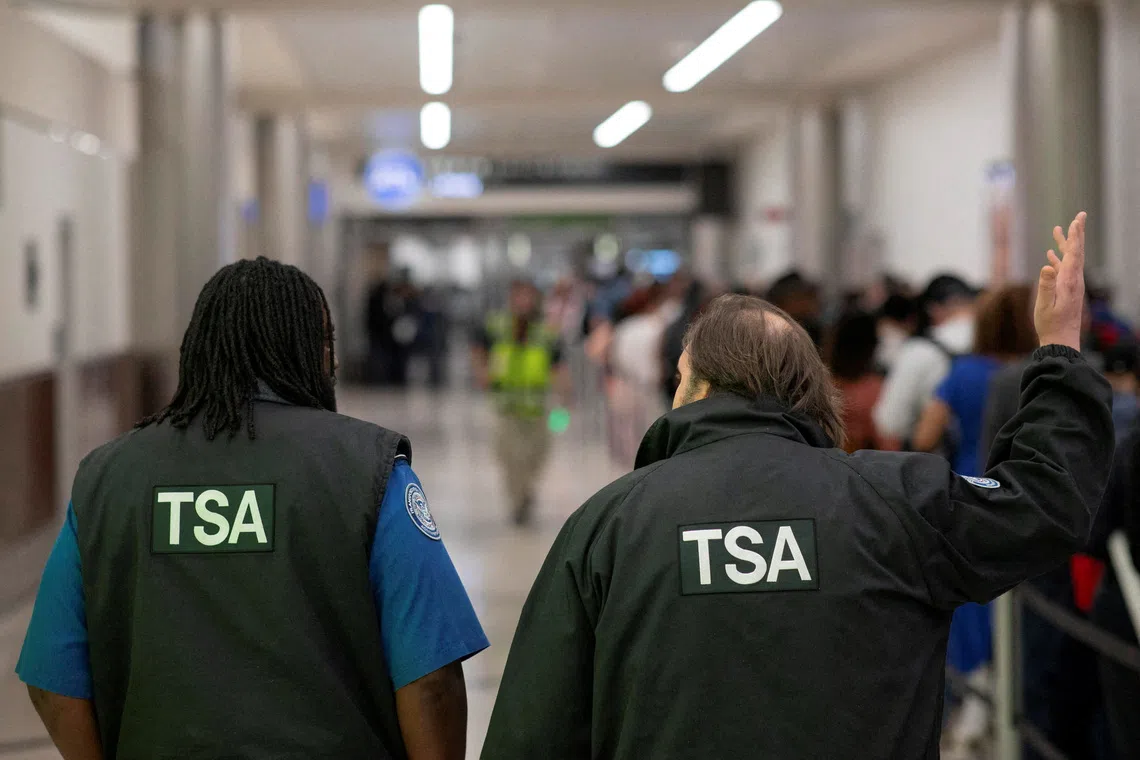 Transportation Security Administration (TSA) officers walk through the domestic terminal at Hartsfield-Jackson Atlanta International Airport in Atlanta, Georgia, U.S. March 27, 2026. REUTERS/Alyssa Pointer     TPX IMAGES OF THE DAY