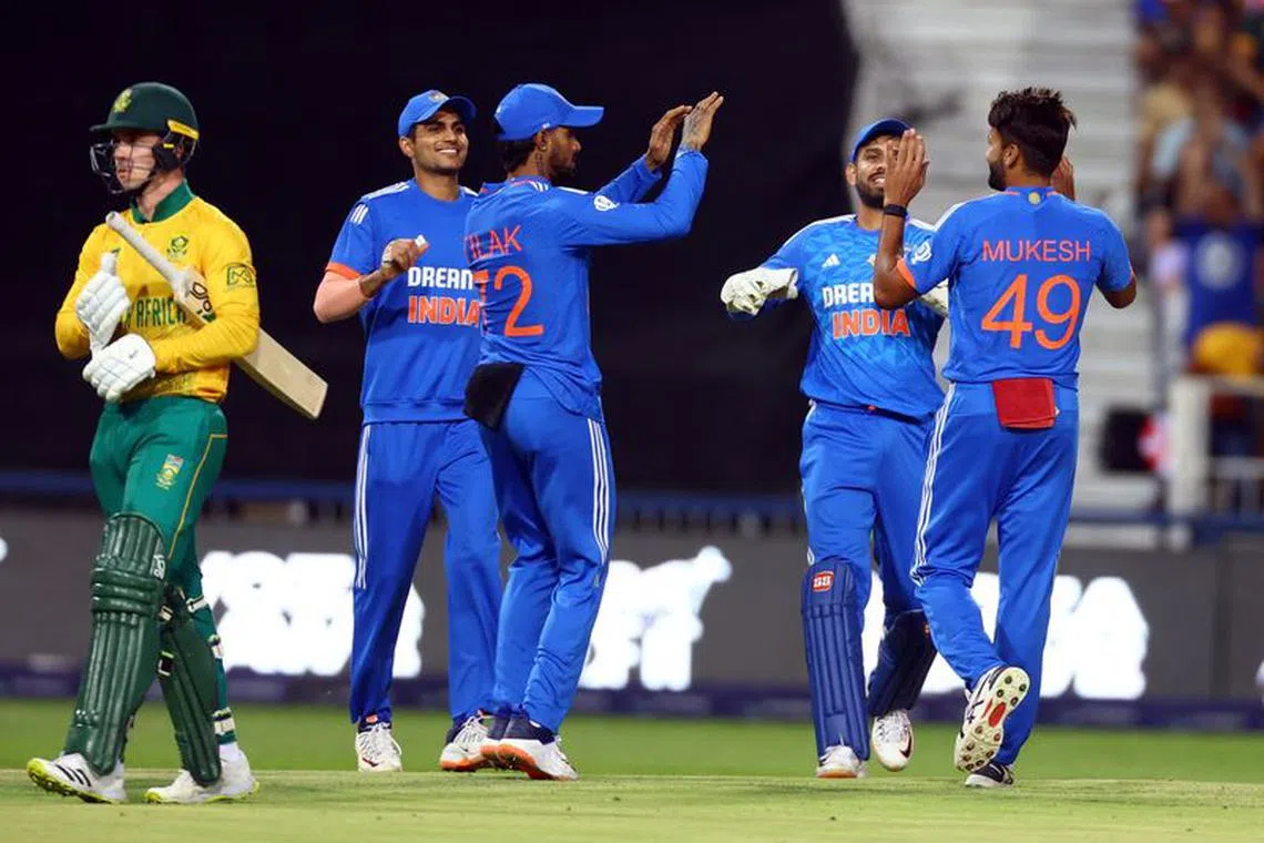 Cricket - Third T20 International - South Africa v India - Wanderers Stadium, Johannesburg, South Africa - December 14, 2023 India's Mukesh Kumar celebrates with teammates after taking the wicket of South Africa's Matthew Breetzke REUTERS/Siphiwe Sibeko