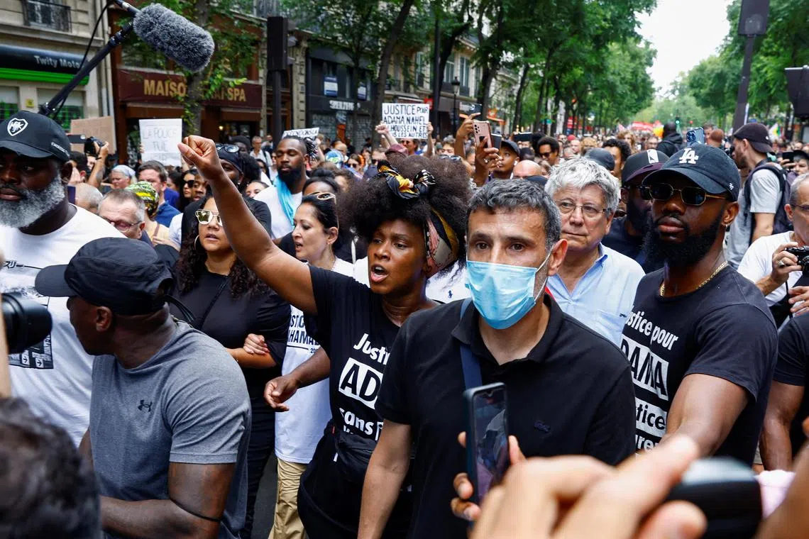 Ms Assa Traore (centre left), sister of Adama Traore, attends a memorial rally for her brother in central Paris after her planned march was banned. 