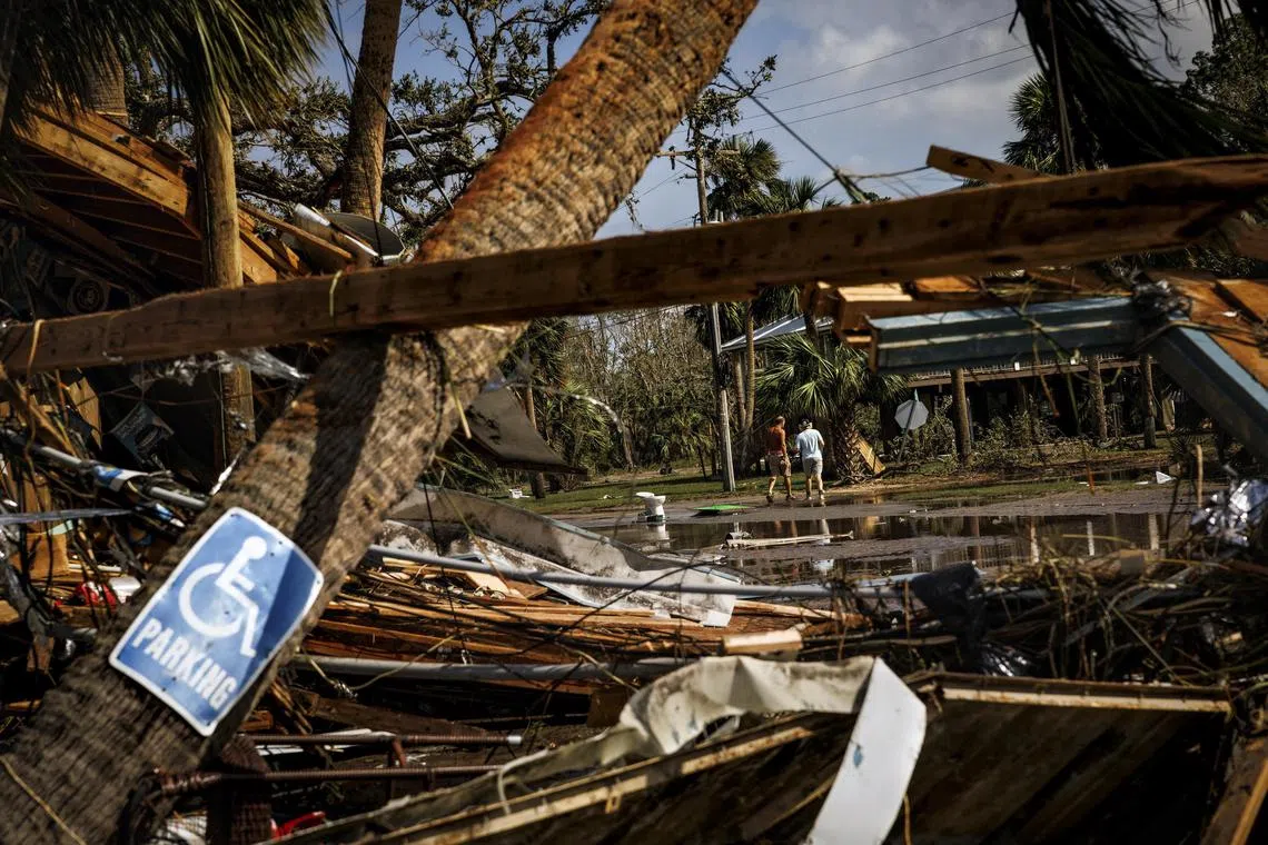 Residents survey the damage from Hurricane Helene in Steinhatchee, a coastal community in Florida, on Sept 27.