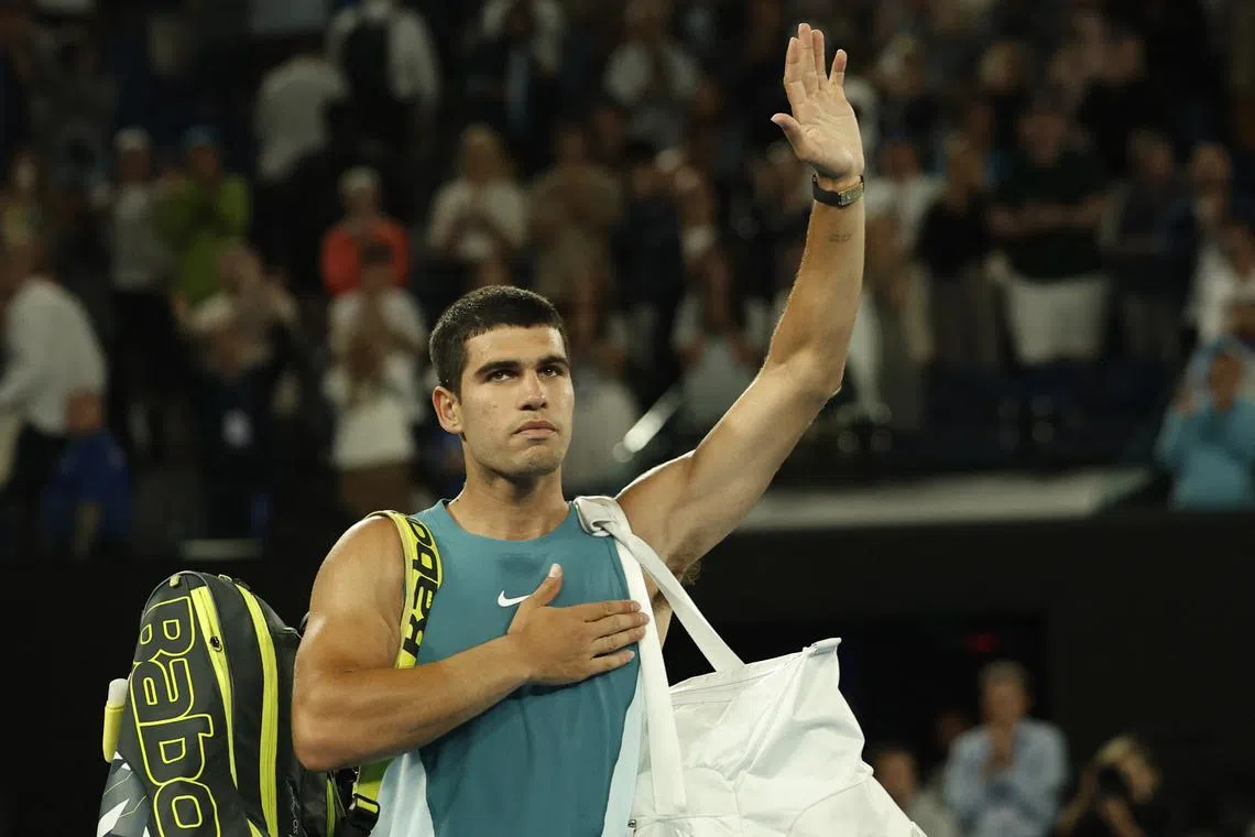 FILE PHOTO: Tennis - Australian Open - Melbourne Park, Melbourne, Australia - January 22, 2025 Spain's Carlos Alcaraz reacts after losing his quarter final match against Serbia's Novak Djokovic REUTERS/Francis Mascarenhas/File Photo