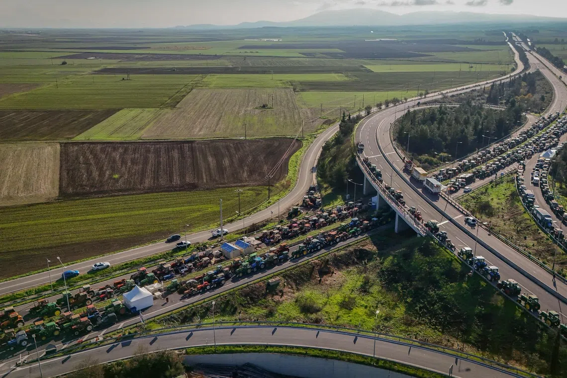 Farmers' tractors blocking a national highway outside the central Greek city of Larissa, on Dec 9, 2025, to demand swifter access to EU subsidies delayed by an ongoing probe into multi-million fraud.  