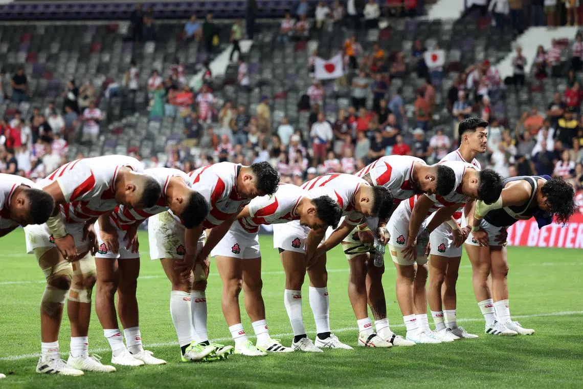 The Japanese players bow towards the crowd at the end of the Rugby World Cup Pool D match against Samoa.