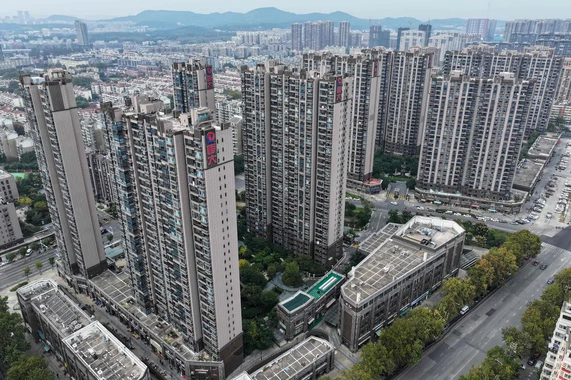 This aerial photo taken on October 25, 2023 shows the Evergrande logo on residential buildings in Nanjing, in China's eastern Jiangsu province. (Photo by AFP) / China OUT