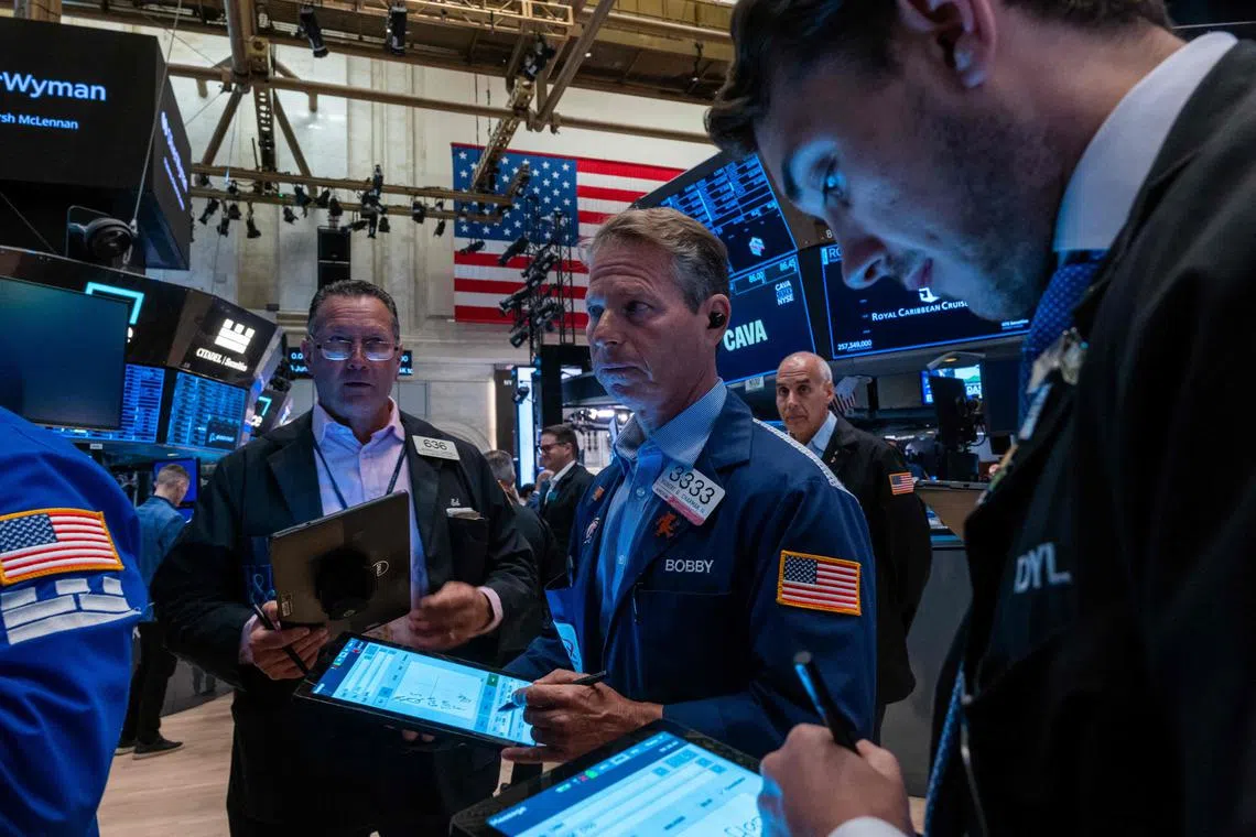 Traders work on the floor of the New York Stock Exchange, in New York City.