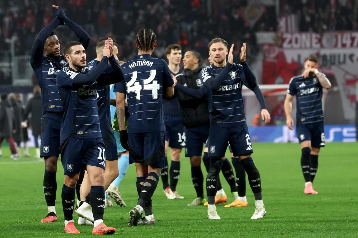 Aston Villa players applaud their fans after winning the Champions League match against RB Leipzig.