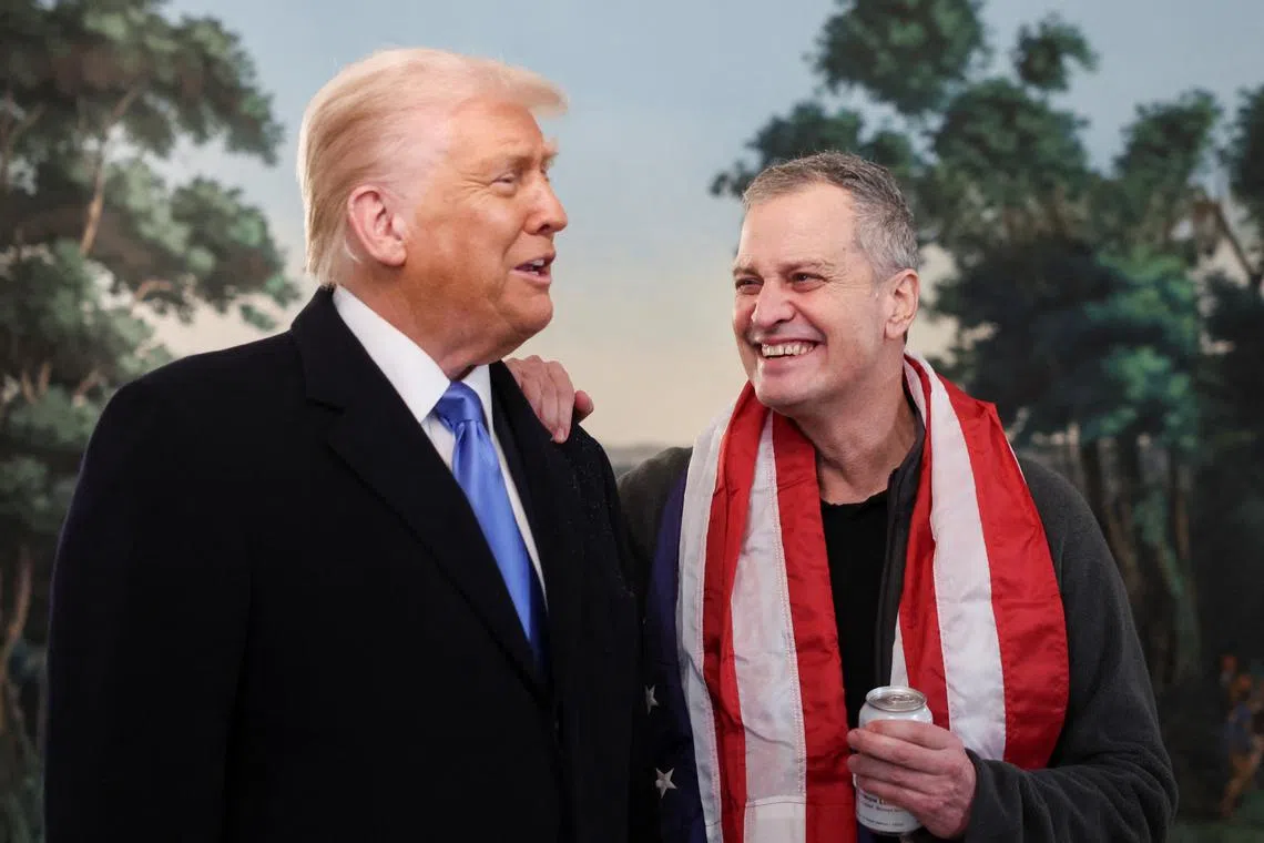 U.S. President Donald Trump and released American schoolteacher Marc Fogel react during an event to welcome back Fogel, who had been held in Russia since 2021, at the White House in Washington, D.C., U.S., February 11, 2025.  REUTERS/Kevin Lamarque