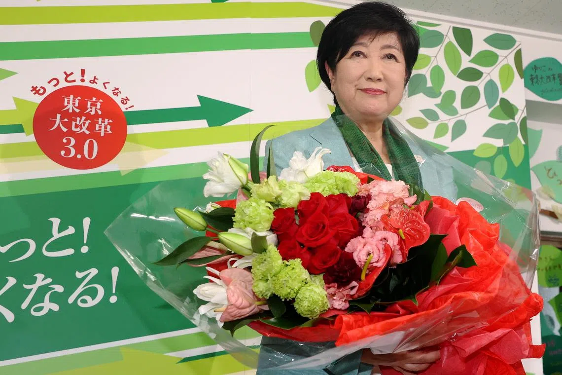 Tokyo Governor Yuriko Koike celebrates after winning the third straight term in Tokyo gubernatorial election on July 7.