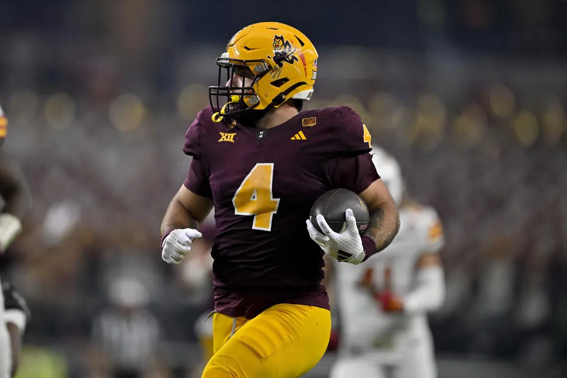 FILE PHOTO: Dec 7, 2024; Arlington, TX, USA; Arizona State Sun Devils running back Cam Skattebo (4) in action during the game between the Iowa State Cyclones and the Arizona State Sun Devils at AT&T Stadium. Mandatory Credit: Jerome Miron-Imagn Images/File Photo