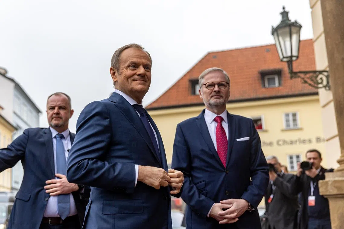 Czech Prime Minister Petr Fiala (right) welcomes Polish Prime Minister Donald Tusk (centre) to Prague.