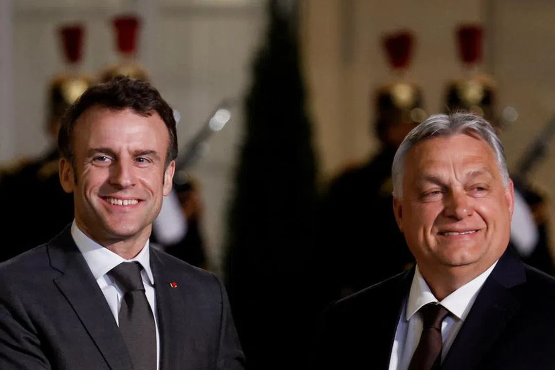 FILE PHOTO: French President Emmanuel Macron welcomes Hungarian Prime Minister Viktor Orban before a meeting at the Elysee Palace in Paris, France March 13, 2023. REUTERS/Gonzalo Fuentes/File Photo