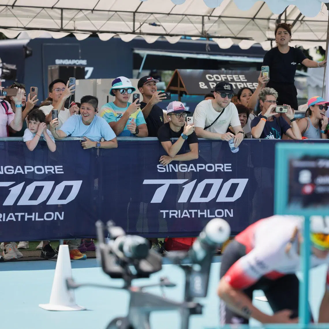 Spectators photographing the participants during the women's T100 Triathlon, held at Singapore's Marina Bay District on April 5, 2025.