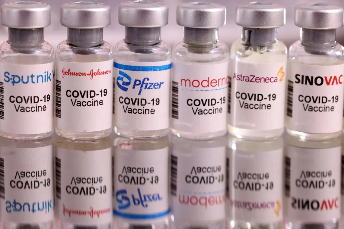 FILE PHOTO: Vials labelled "Sputnik V, Johnson & Johnson, Pfizer, Moderna, AstraZeneca, Sinovac COVID-19 Vaccine" are seen in this illustration taken January 16, 2022. REUTERS/Dado Ruvic/Illustration/File Photo