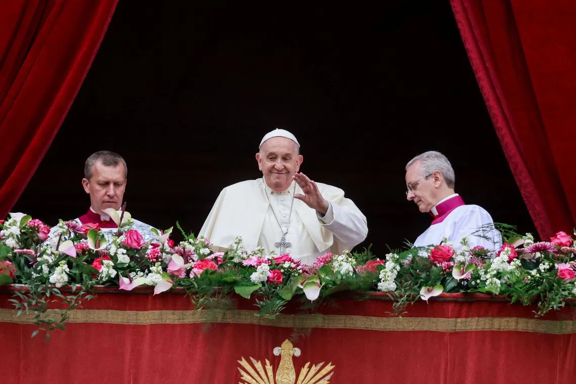 Pope Francis waves from a balcony, on the day he delivers his \"Urbi et Orbi\" (To the city and the world) message at St. Peter's Square, on Easter Sunday, at the Vatican March 31, 2024. REUTERS/Yara Nardi