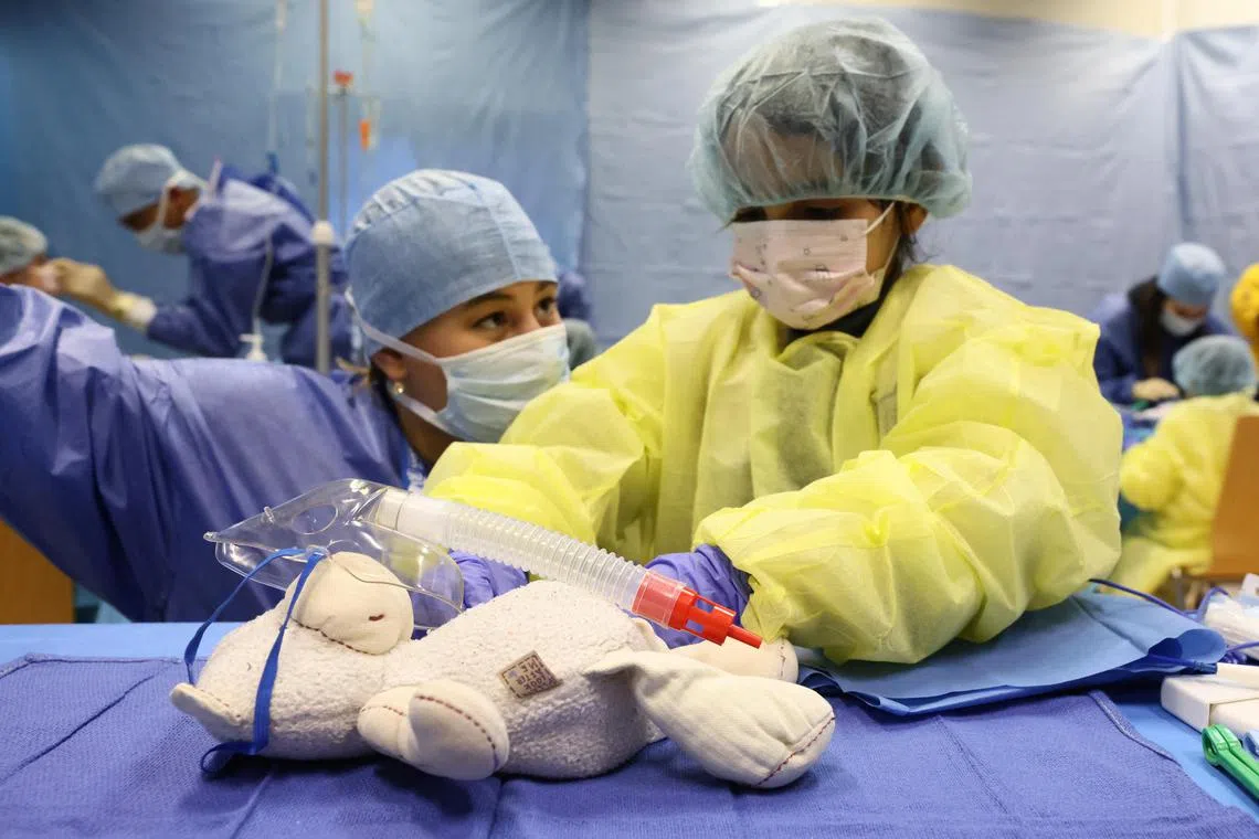 A medical student acting as specialist staff, was accompanied by a child who came with a plush toy to be treated at The Teddy Bear Clinic (Clinique du Nounours), a facility that helps children to cope with their fear of medical examinations, in Brussels, Belgium March 7, 2023. 