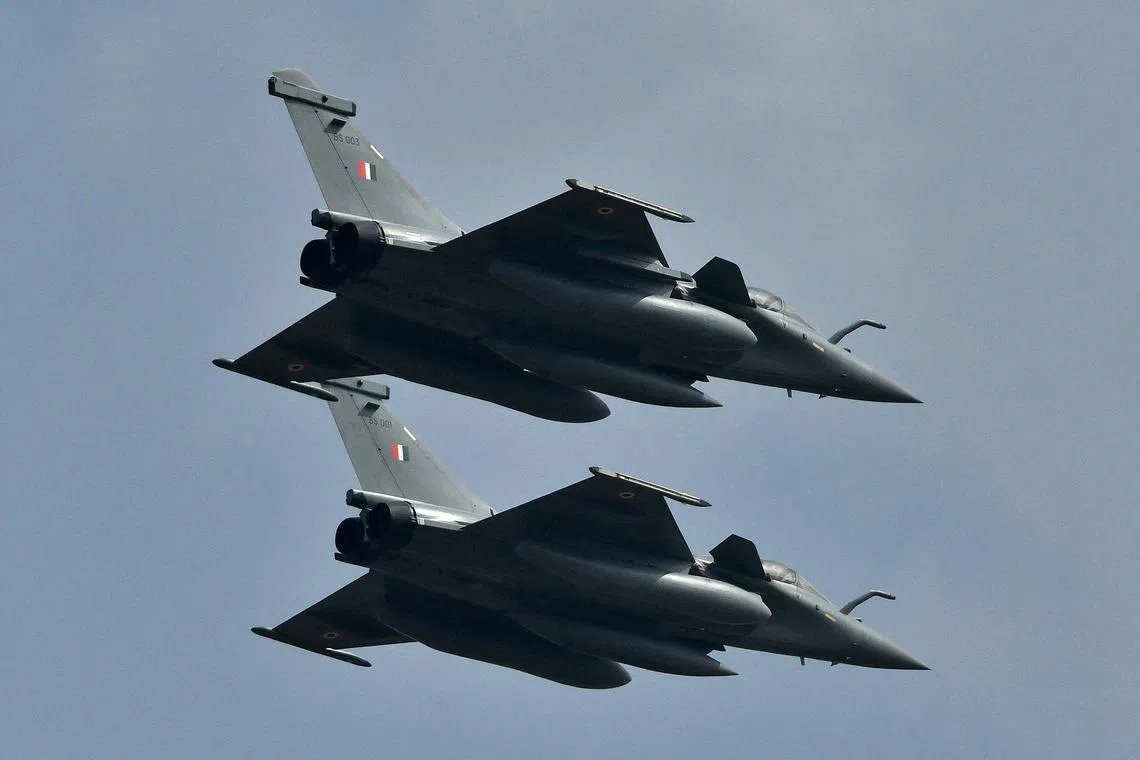 FILE PHOTO: Indian Air Force's Rafale fighter jets fly past during the \"Aero India 2021\" air show at Yelahanka air base in Bengaluru, India, February 3, 2021. REUTERS/Samuel Rajkumar/File Photo