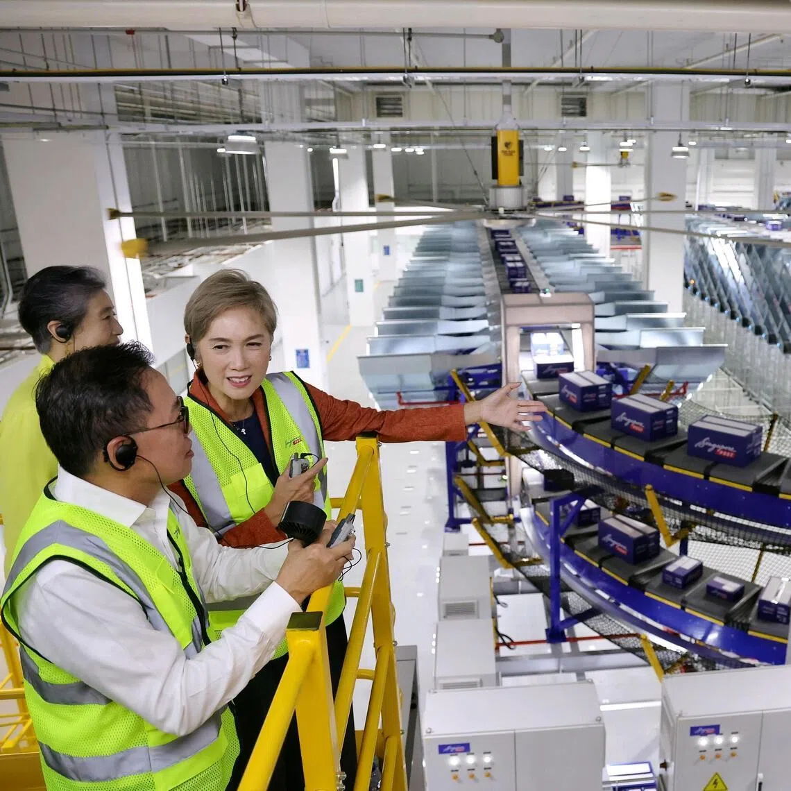 Minister for Digital Development and Information Josephine Teo, accompanied by SingPost CEO Mark Chong and chairman Teo Swee Lian, viewing the intelligent flexi sorter at the launch of SingPost's new S$30 million automated parcel sortation facility within the Regional eCommerce Logistics Hub in Greenwich Drive on June 9, 2026.