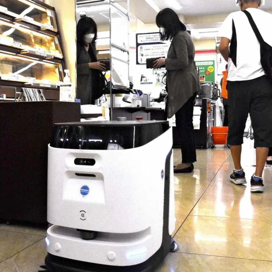 A robot cleans the floor at a 7-Eleven store in Tokyo's Arakawa War on Sept 9, 2025.