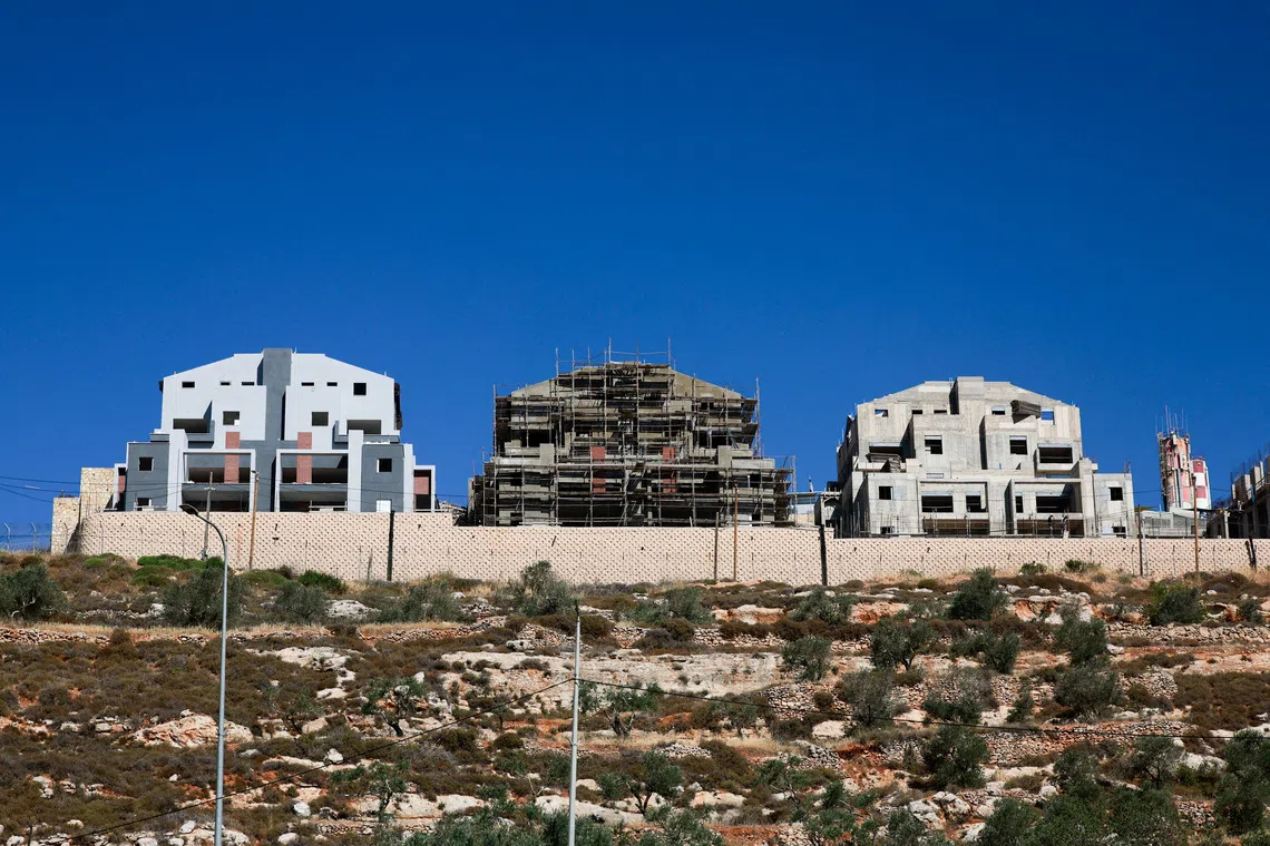 FILE PHOTO: New buildings stand around the Israeli settlement Migdalim near Nablus, in the Israeli-occupied West Bank, May 30, 2025. REUTERS/Ammar Awad/File Photo