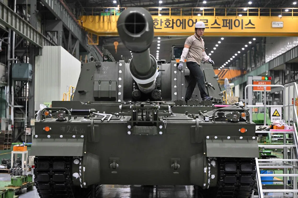 A South Korean engineer works on a K-9 self propelled howitzer at Hanwha Aerospace factory in Changwon.