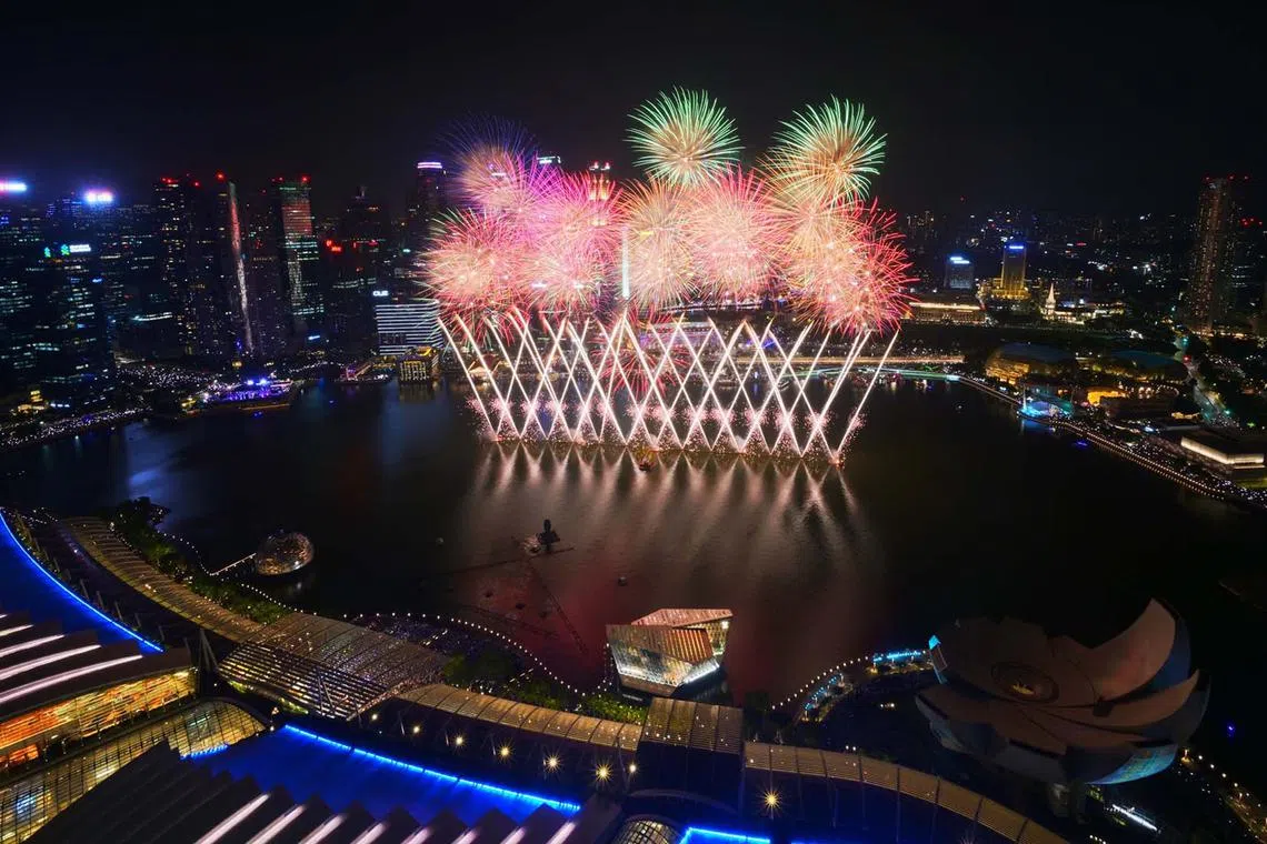 Fireworks firing off at midnight at Singapore's Marina Bay to celebrate the new year, Jan 1, 2024.